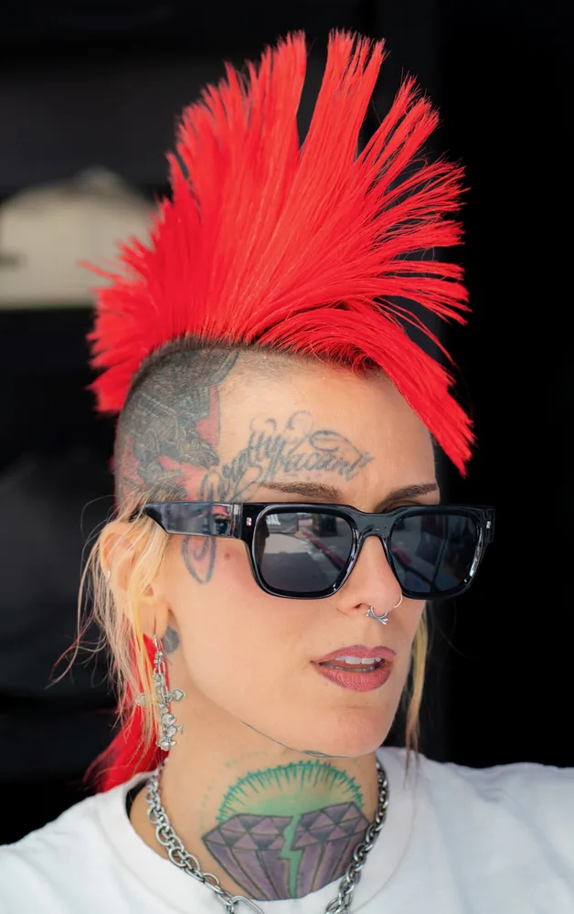 Bold profile portrait with a vivid red mohawk